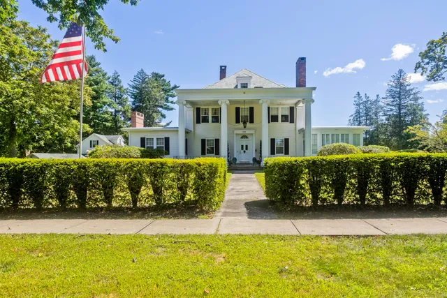 a front view of a house with a yard