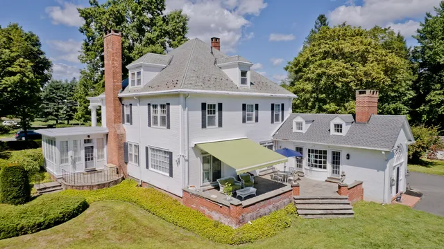 an aerial view of a house with swimming pool and a yard