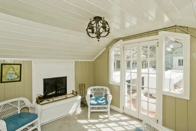 a living room with furniture a flat screen tv and a table