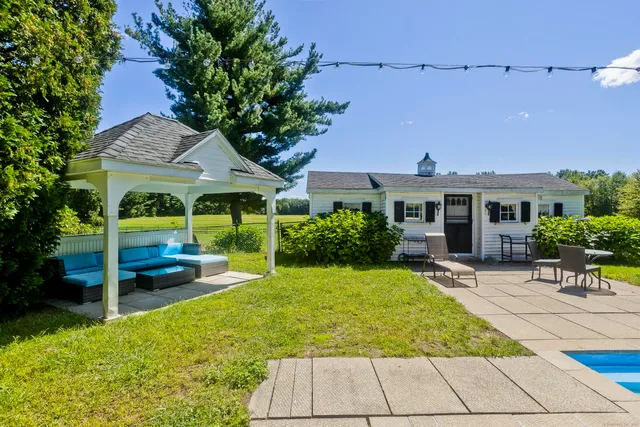 a view of a house with backyard porch and sitting area