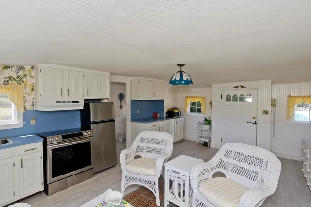 a kitchen with a refrigerator and a stove top oven