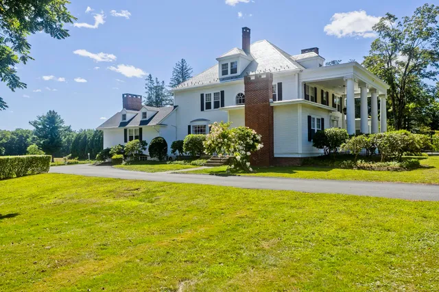 a front view of house with outdoor space and swimming pool