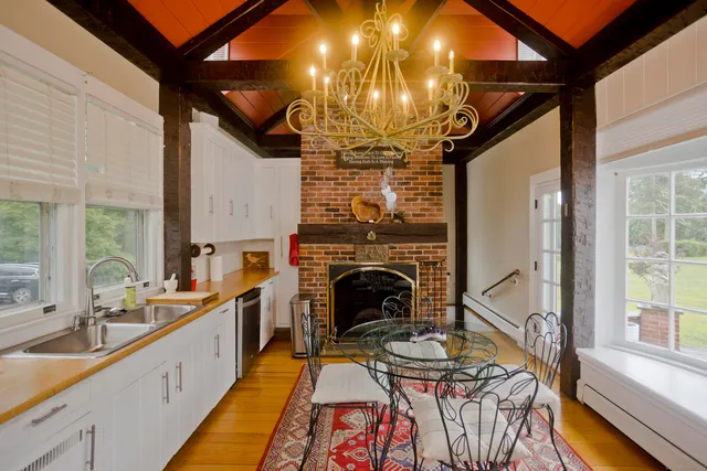 a very nice looking dining room with a fireplace and a large window