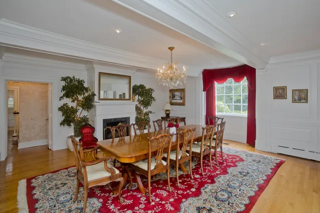 a view of a dining room with furniture and a chandelier