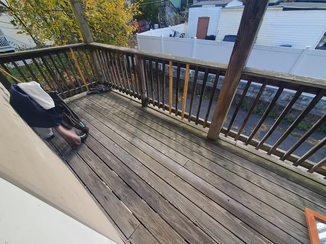 a view of balcony with wooden floor