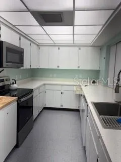 a kitchen that has a sink and a stove