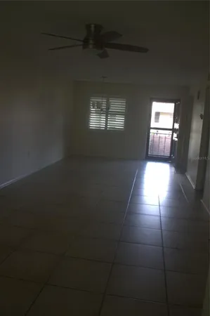 a view of a hallway with wooden floor and cabinet