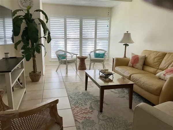 a living room with furniture a rug and a window