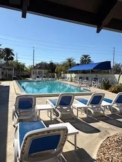 a roof deck with table and chairs