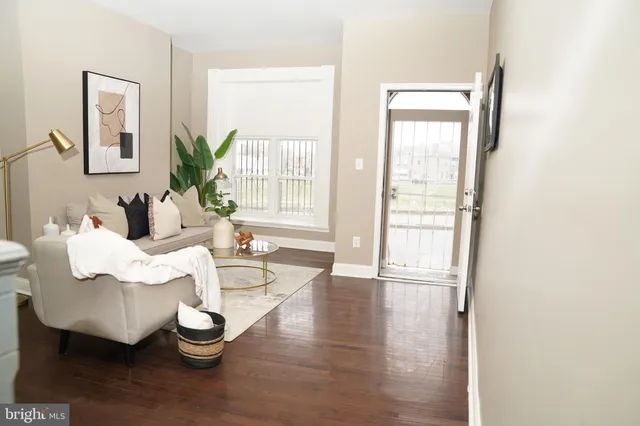 a living room with furniture and wooden floor