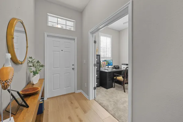 a view of an entryway with wooden floor