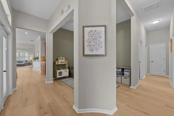 a view of a hallway view with wooden floor and furniture