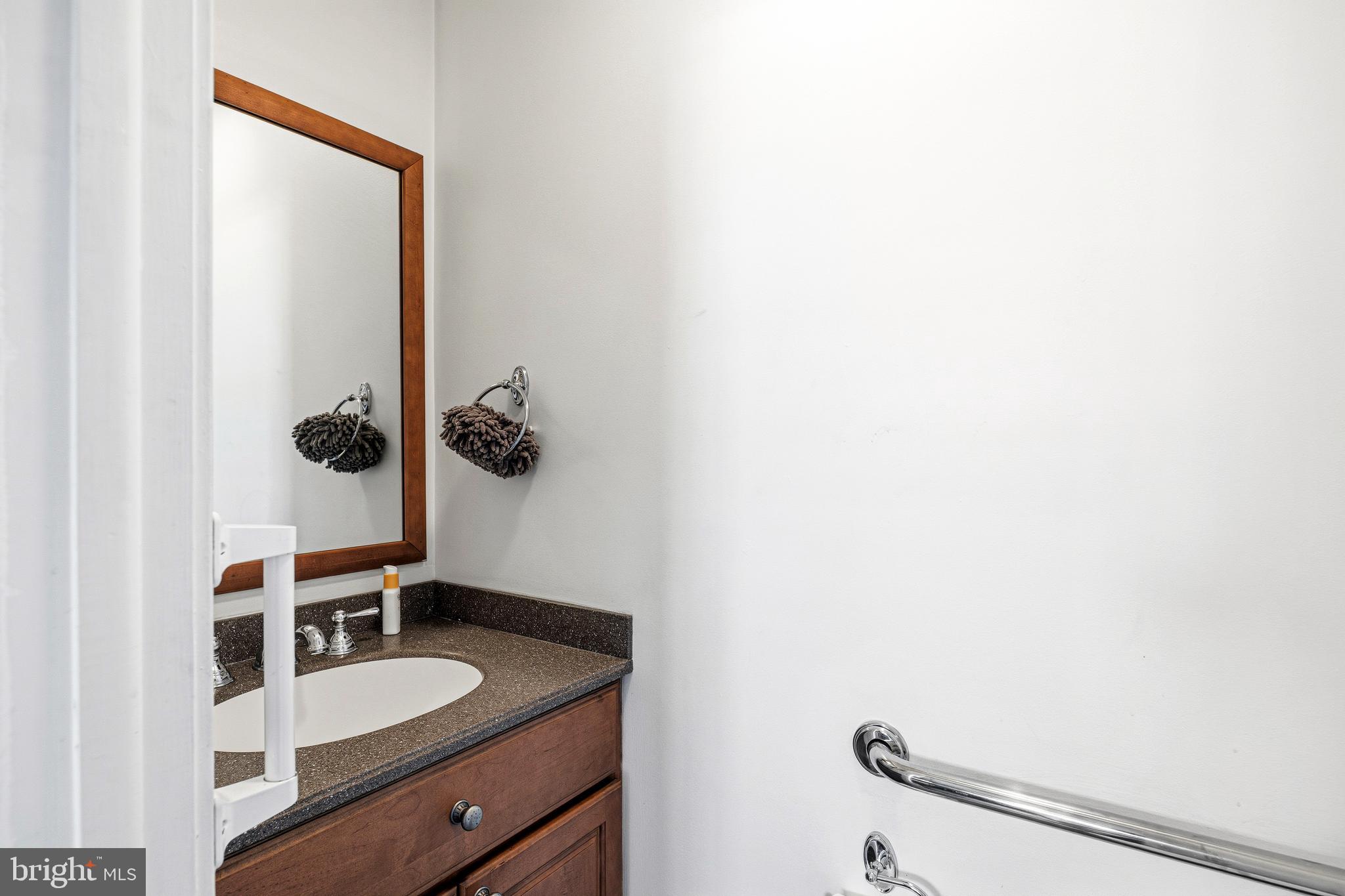 256 Hawthorne Avenue Haddonfield, NJ 08033 - Photo 15 of 17 a bathroom with a granite countertop sink and a mirror