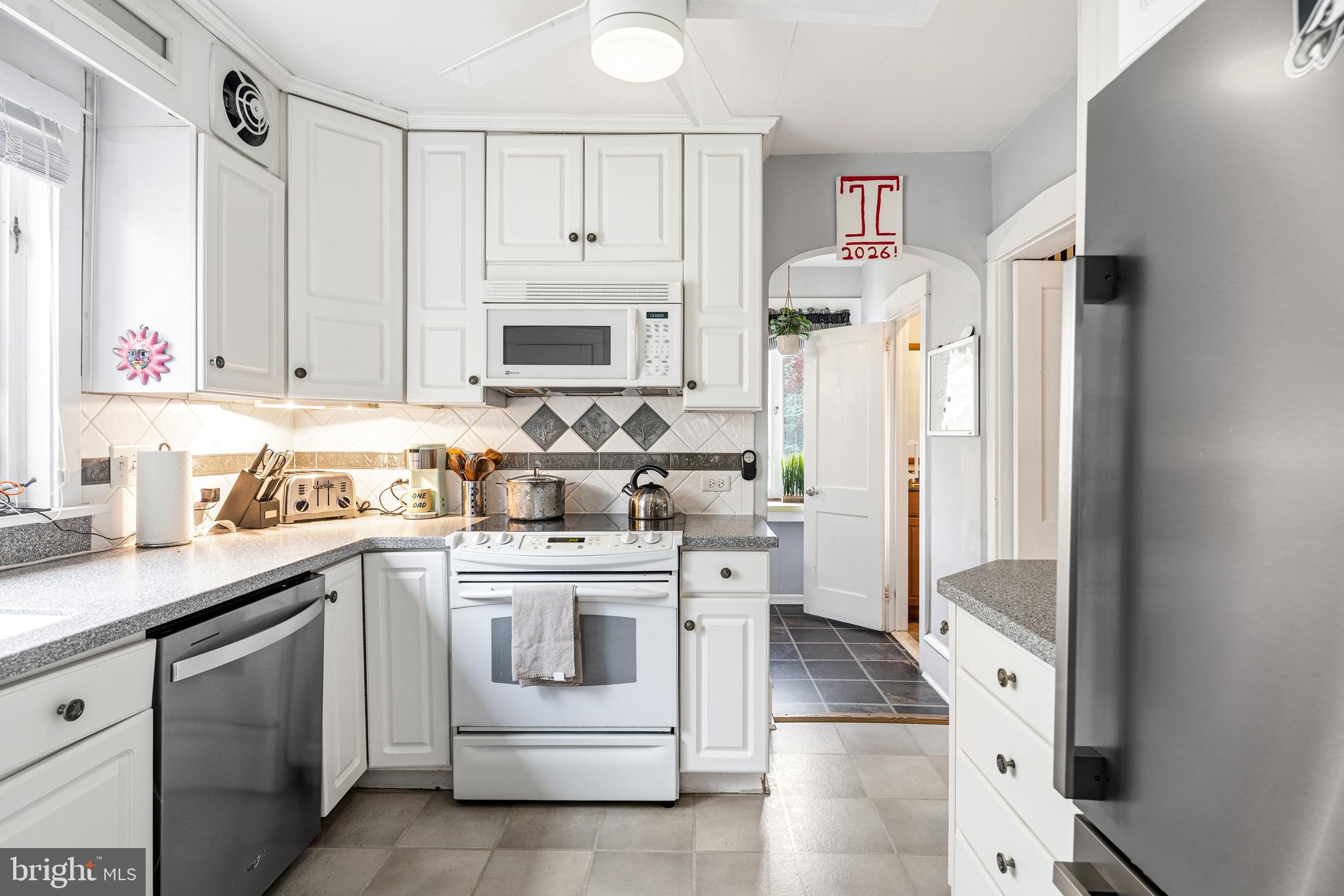 256 Hawthorne Avenue Haddonfield, NJ 08033 - Photo 7 of 17 a kitchen with stainless steel appliances a refrigerator sink and cabinets