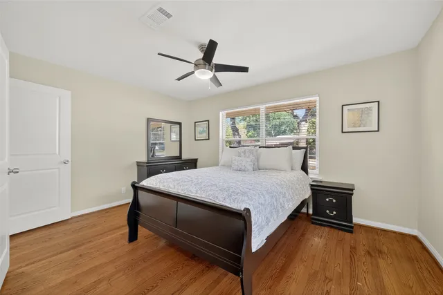 a bathroom with a granite countertop sink a toilet and a mirror