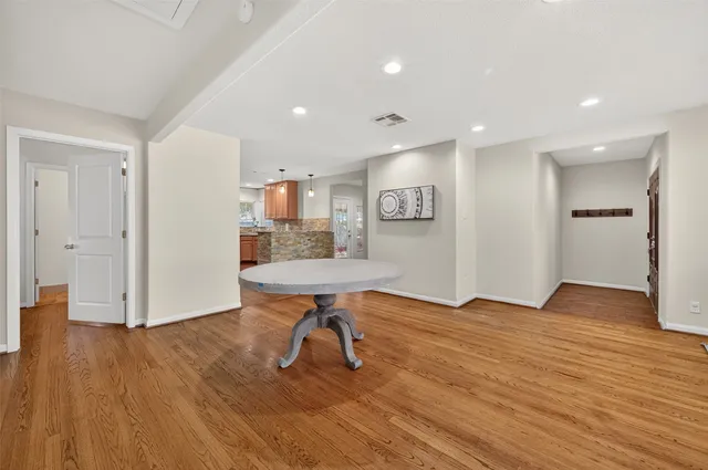 a kitchen with refrigerator cabinets and wooden floor