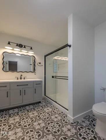 a room with a wooden floor and white doors