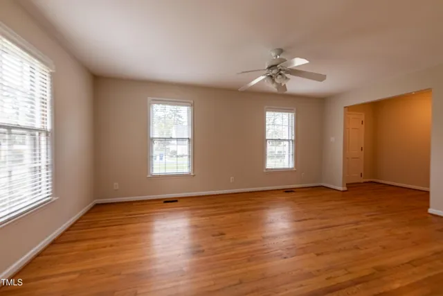 wooden floor in an empty room with a window