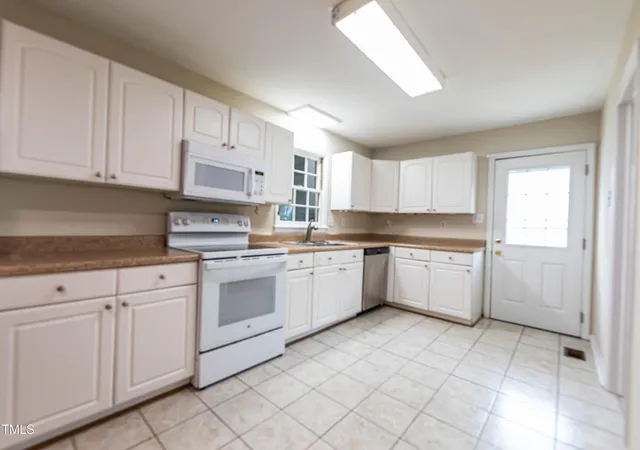 a kitchen with cabinets and white appliances