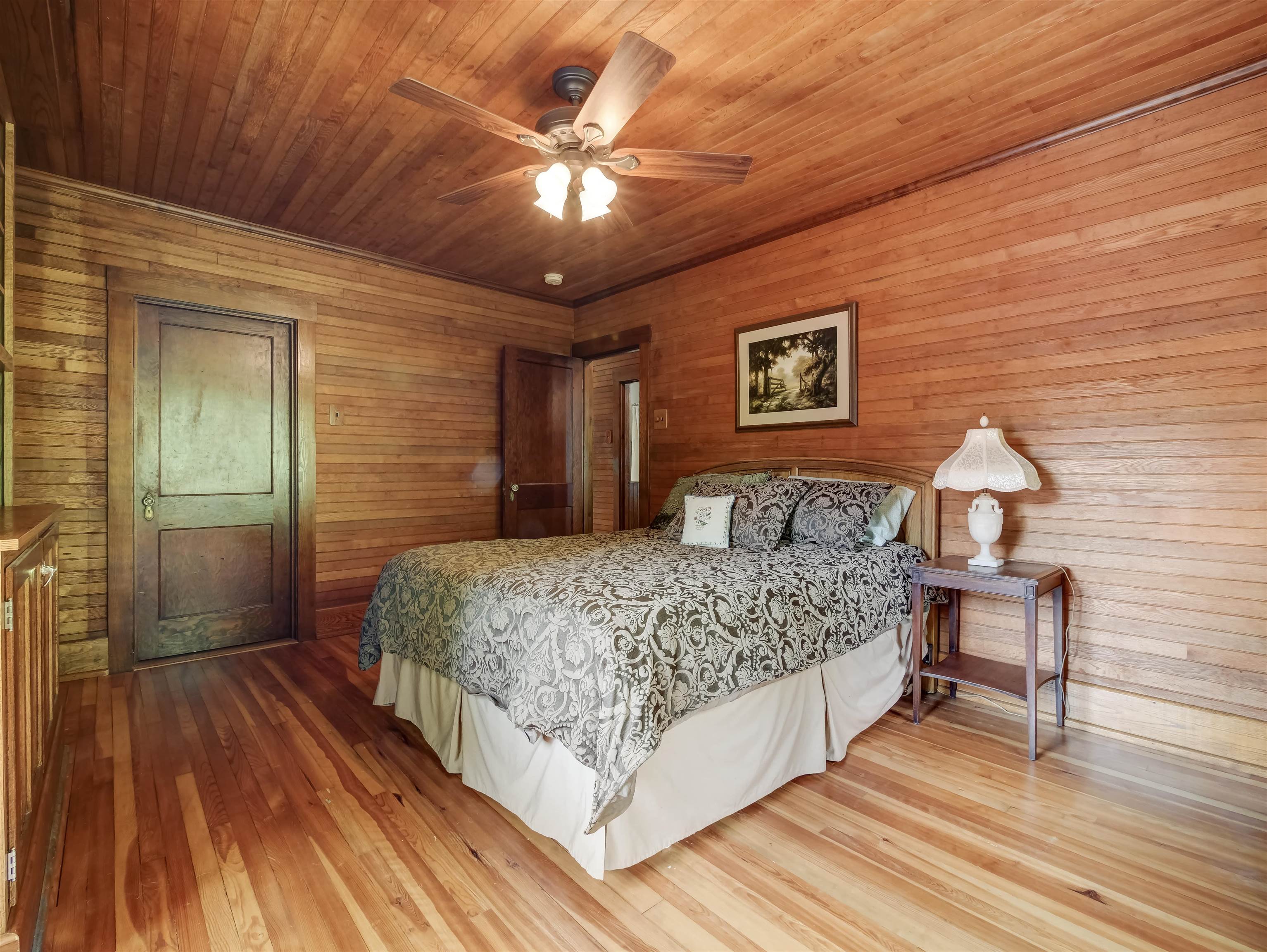 7304 Dry Run Road Williamsville, VA 24487 - Photo 36 of 57 a spacious bedroom with a bed and a chandelier