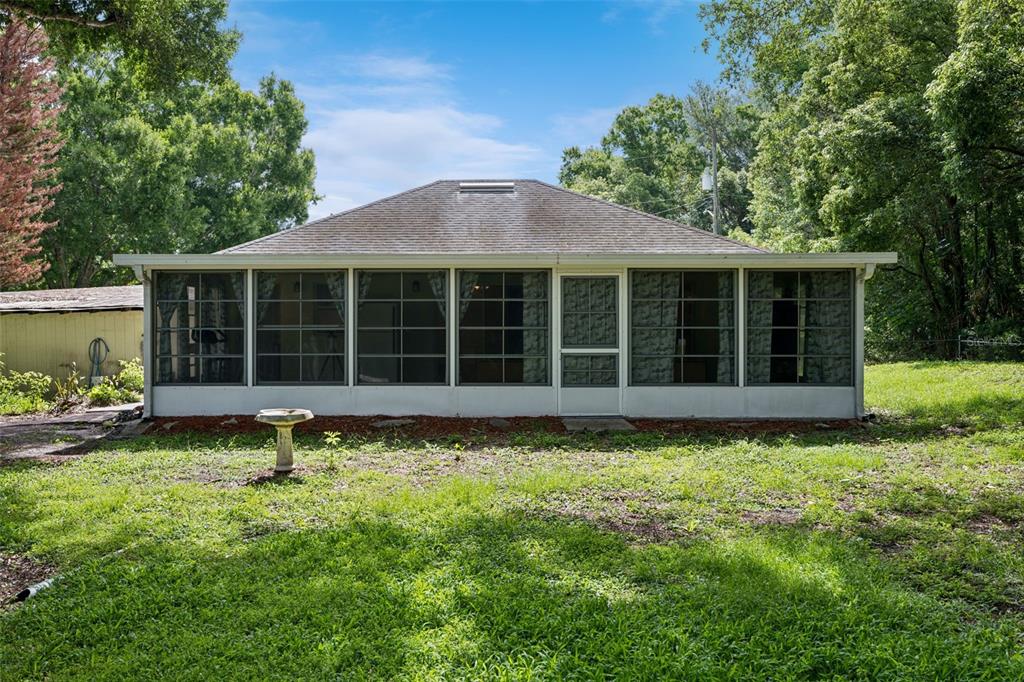 420 Jacks Memorial Road St. Cloud, FL 34769 - Photo 19 of 31 a view of a house with a large window and a yard
