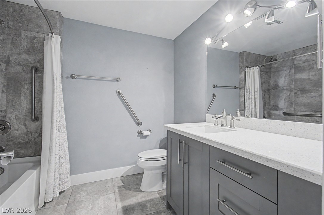 2555 Hampton Road, Unit 6308 Henderson, NV 89052 - Photo 22 of 30 Second bathroom featuring a vanity with gray cabinetry, custom lights and step-in bath/shower & new toilet.