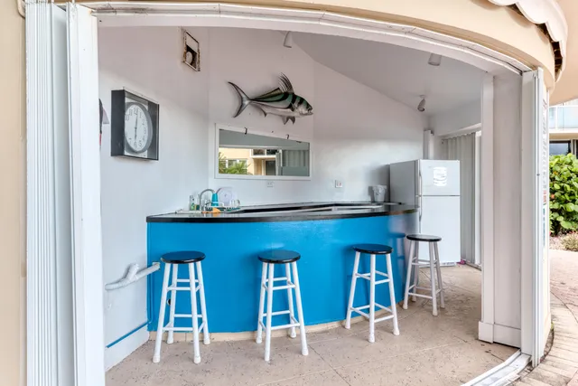 a living room with table chairs and a window
