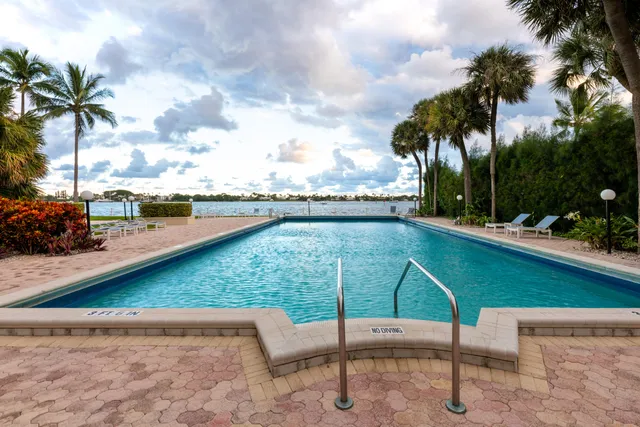 a view of swimming pool with a table and chairs