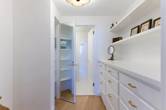 a bathroom with a double vanity sink a mirror and a shower