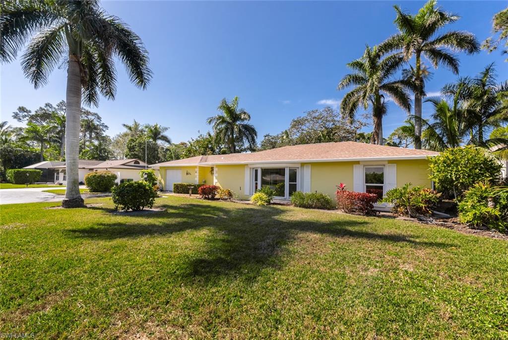 Single story home with a front yard
