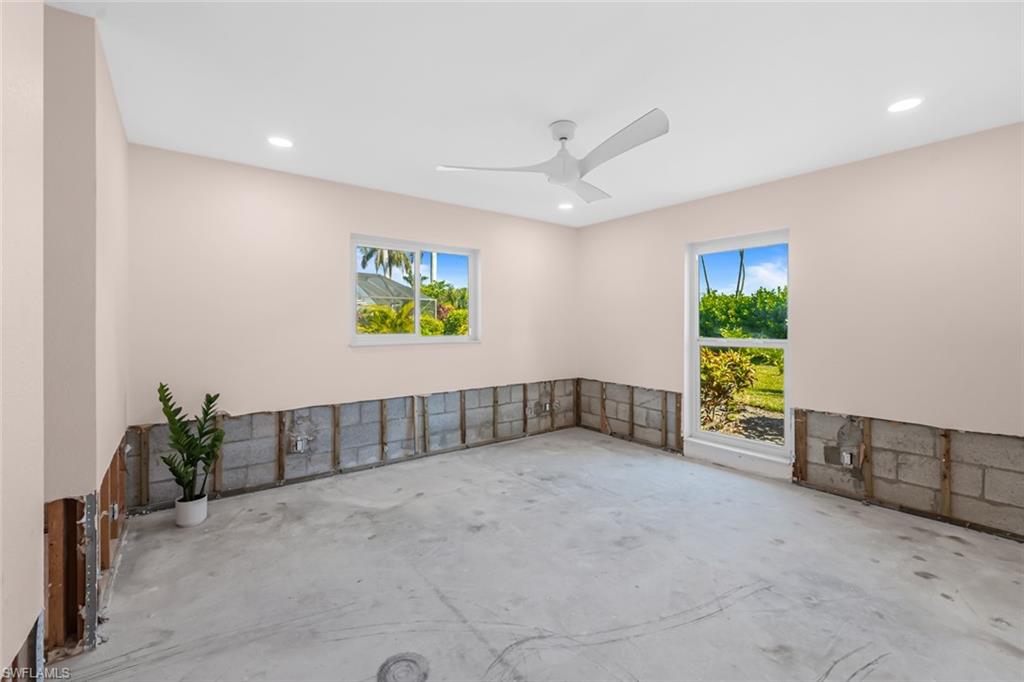 24 Rivard Road, Unit 12 Naples, FL 34112 - Photo 12 of 27 Unfurnished room featuring ceiling fan, concrete floors, and a wealth of natural light