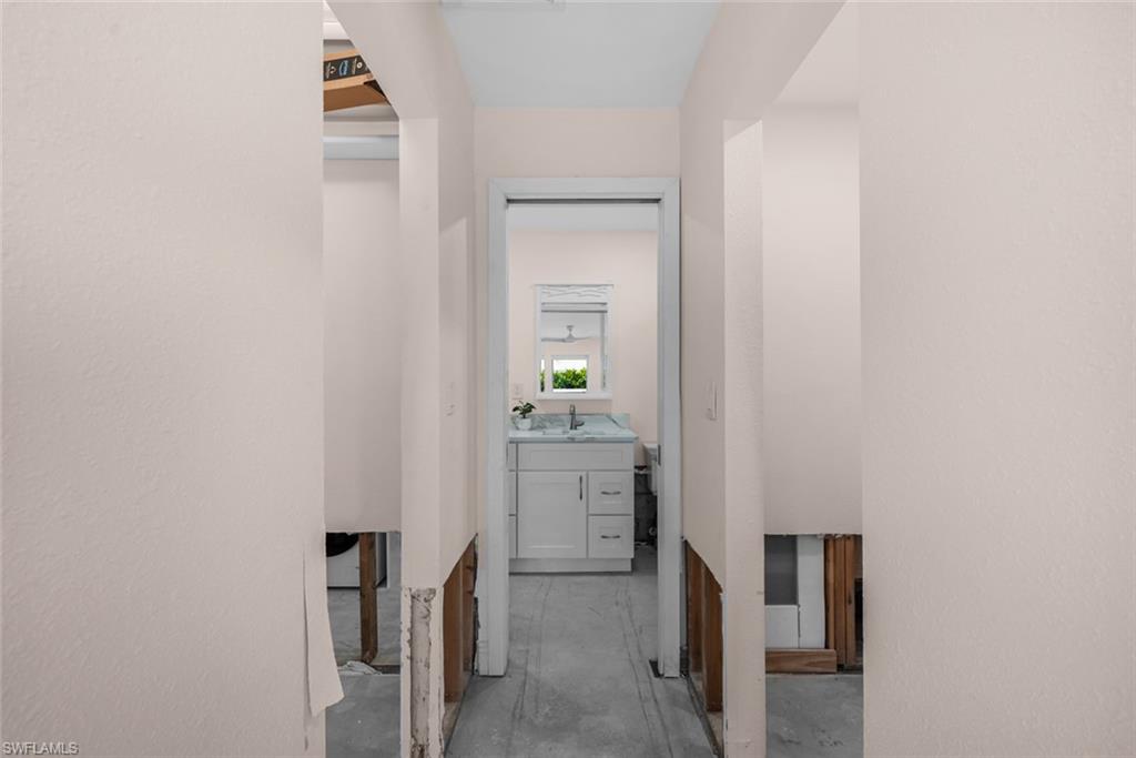 24 Rivard Road, Unit 12 Naples, FL 34112 - Photo 14 of 27 Hallway featuring sink