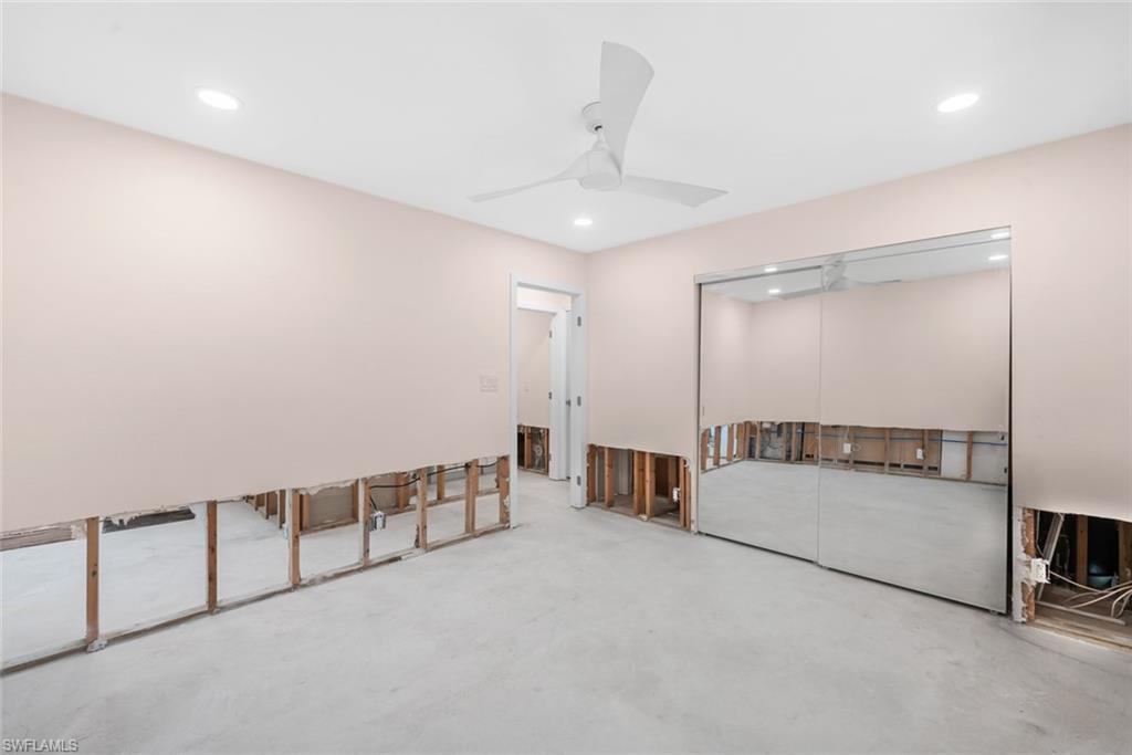 24 Rivard Road, Unit 12 Naples, FL 34112 - Photo 19 of 27 Bedroom featuring a closet, concrete floors, and ceiling fan