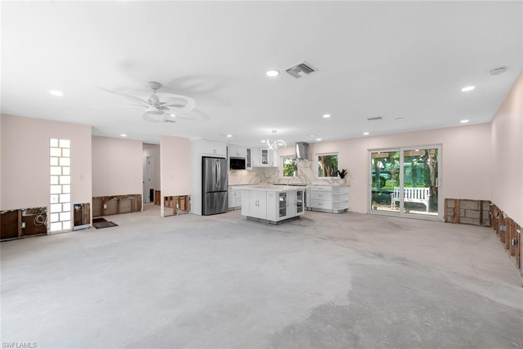 24 Rivard Road, Unit 12 Naples, FL 34112 - Photo 9 of 27 Unfurnished living room featuring ceiling fan