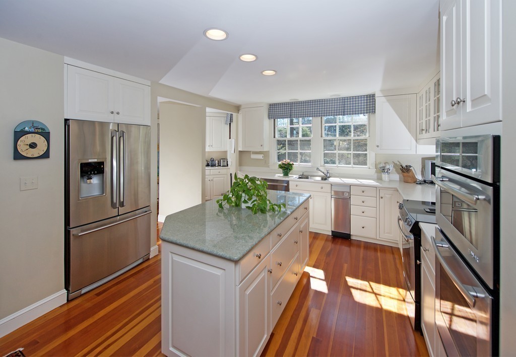17 Bradlee Road Marblehead, MA 01945 - Photo 5 of 28 a kitchen with white cabinets and stainless steel appliances