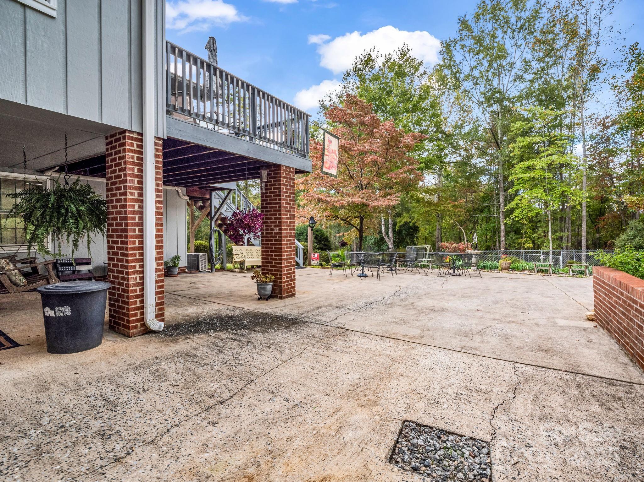 343 Nebraska Street Spindale, NC 28160 - Photo 13 of 46 a view of a patio with table and chairs potted plants and large tree