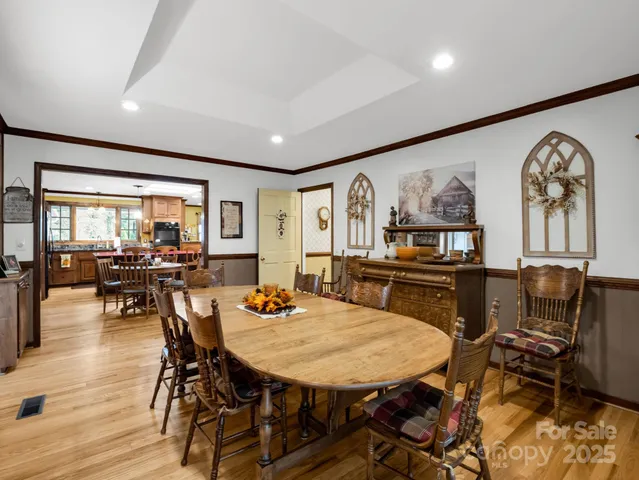 a dining room with furniture and wooden floor