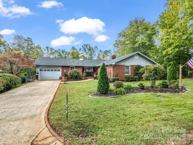 a view of house with yard and green space