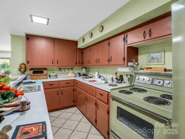 a kitchen with stainless steel appliances a table and chairs in it