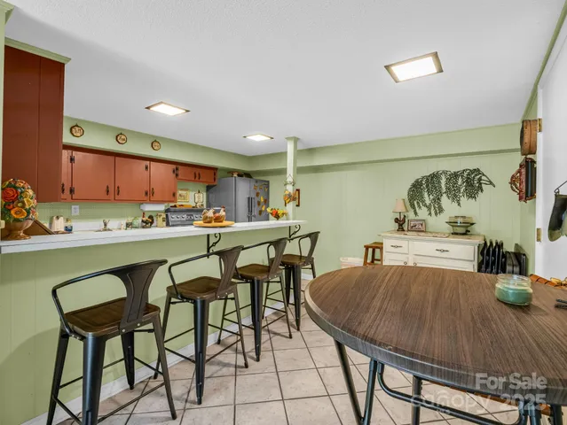 a bedroom with a bed dresser and wooden floor