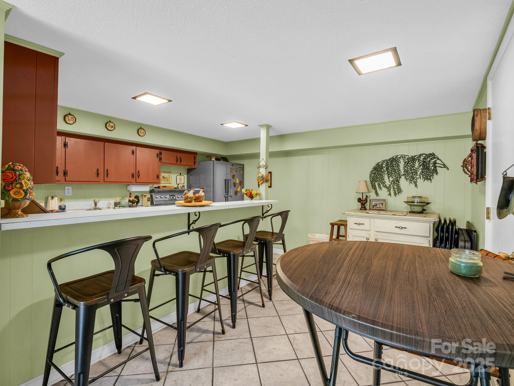 343 Nebraska Street Spindale, NC 28160 - Photo 43 of 46 a kitchen with stainless steel appliances a table and chairs in it