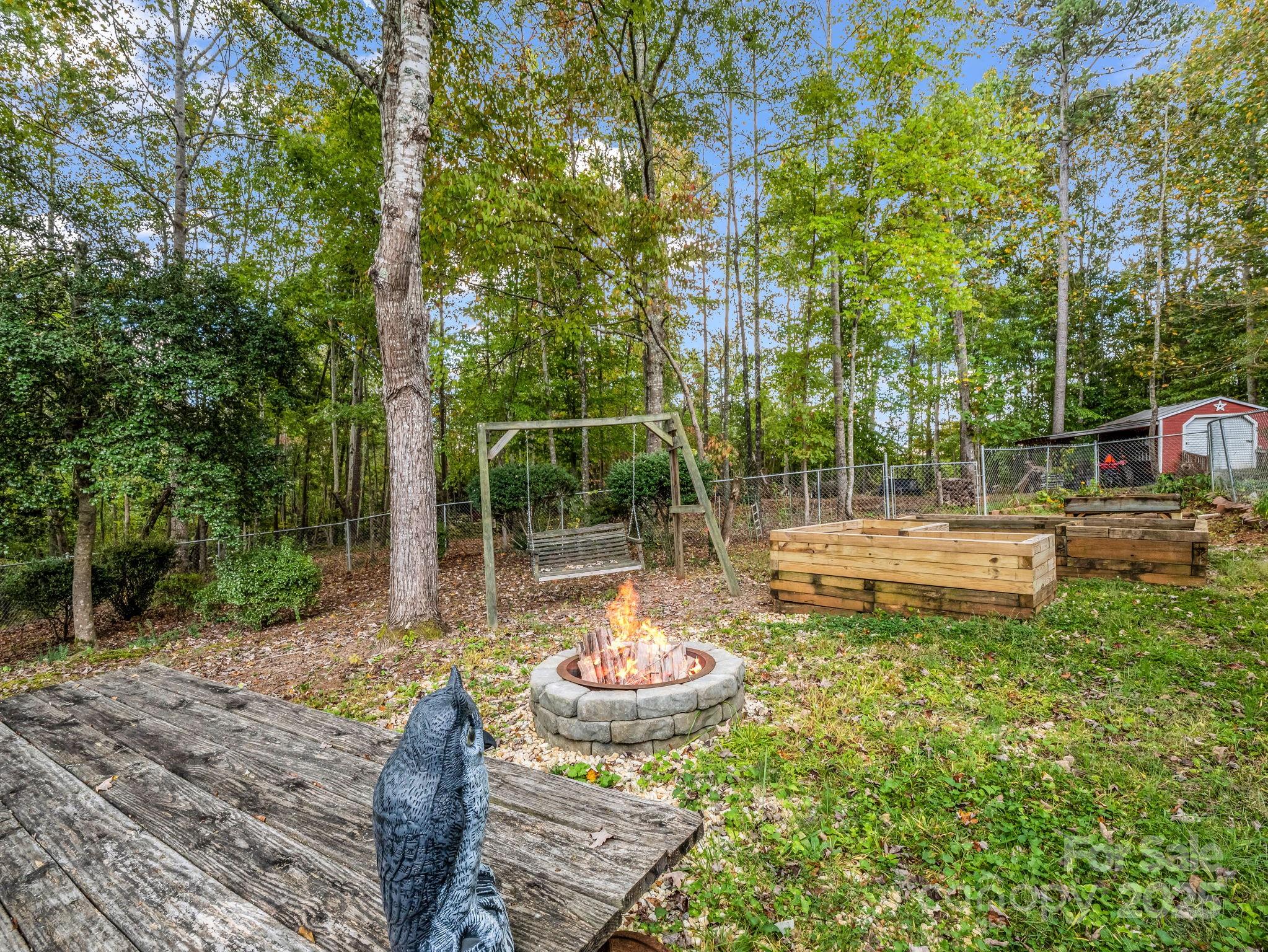 343 Nebraska Street Spindale, NC 28160 - Photo 7 of 46 a view of a backyard with table and chairs potted plants and large tree