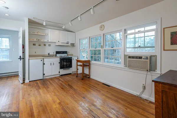 a kitchen with stainless steel appliances a stove top oven and a sink