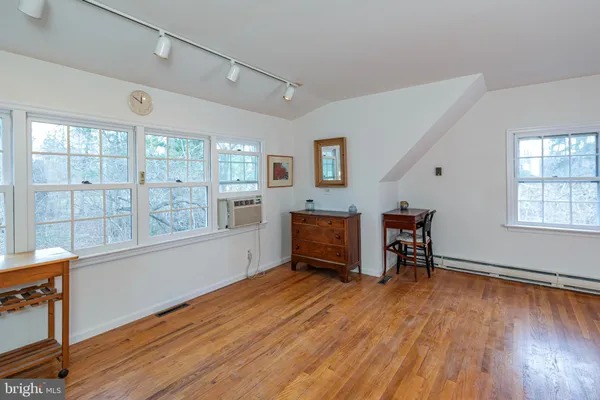 a view of room with window and wooden floor