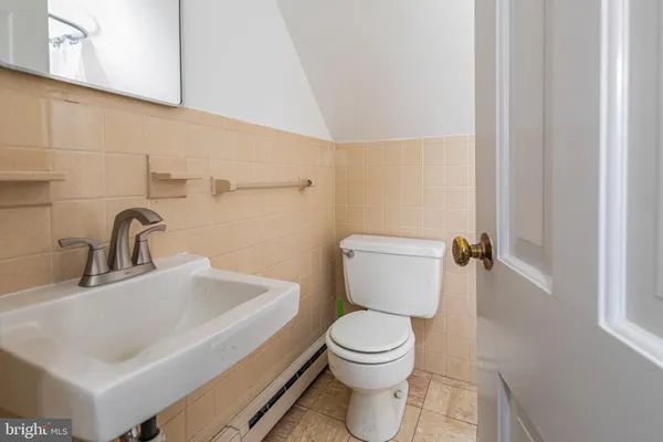 a white toilet sitting next to a bathroom sink