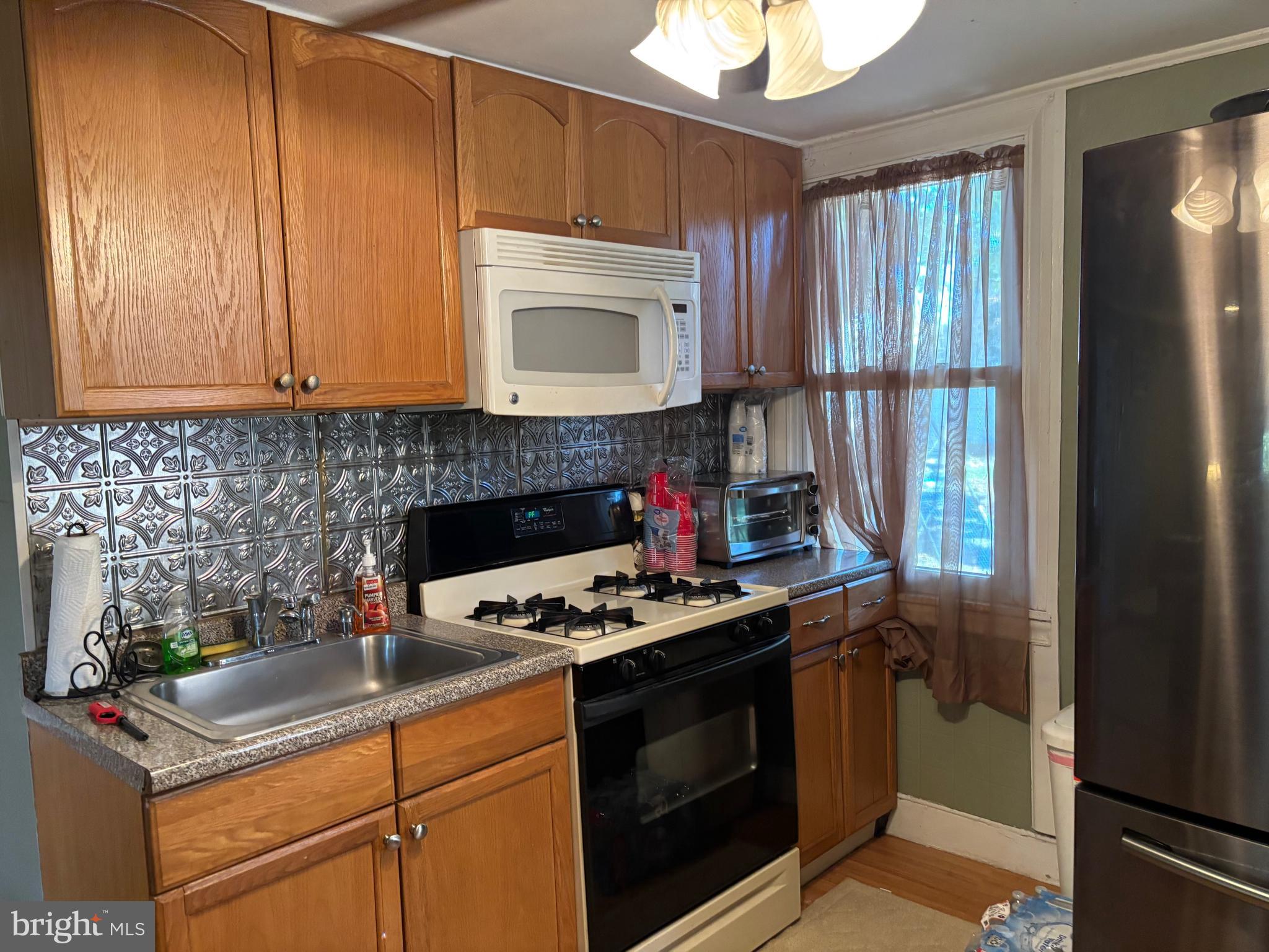 70 Main Street Waretown, NJ 08758 - Photo 27 of 55 a kitchen with a stove and a cabinet