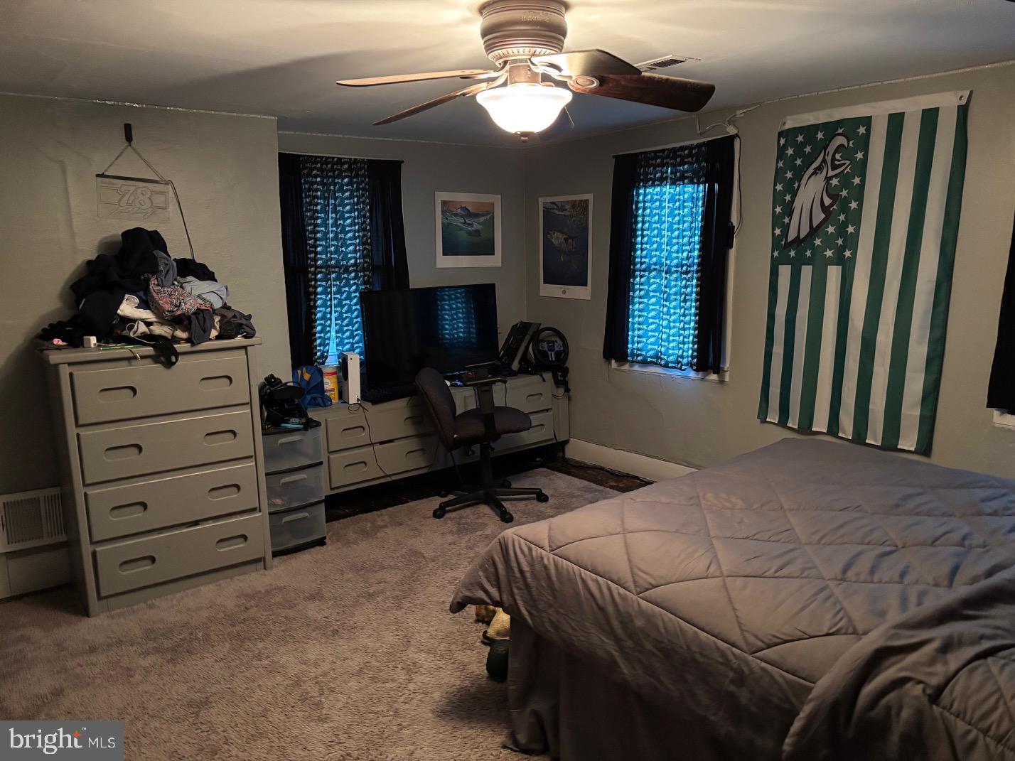 70 Main Street Waretown, NJ 08758 - Photo 38 of 55 a bedroom with a bed and a chandelier