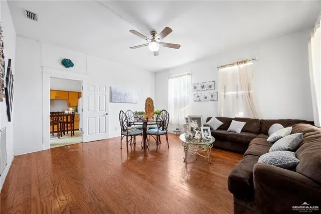 a living room with furniture and wooden floor