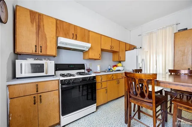 a kitchen with stainless steel appliances granite countertop a stove and a refrigerator