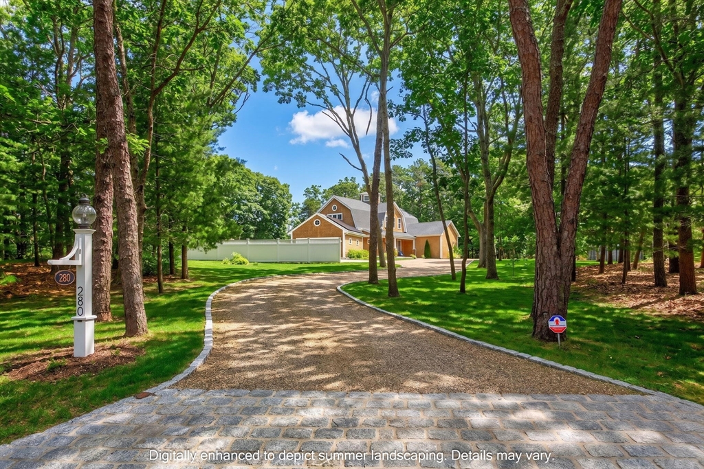 a front view of a house with yard and green space
